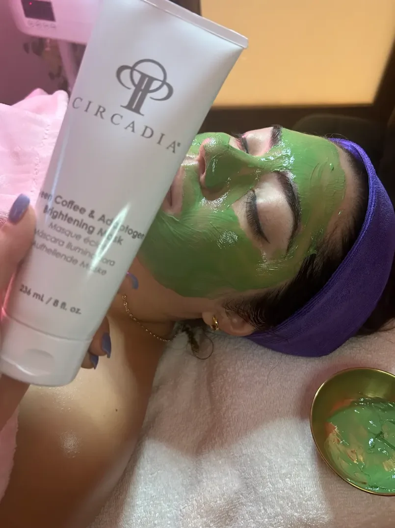 Circadia brightening mask held beside a client wearing the green mask